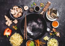 StockFood_12506343_Layout_An_arrangement_of_a_wok_and_ingredients_for_an_oriental_noodle_dish_seen_from_above-min